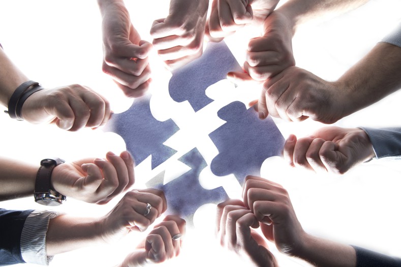 Team effort to solve a jigsaw puzzle.