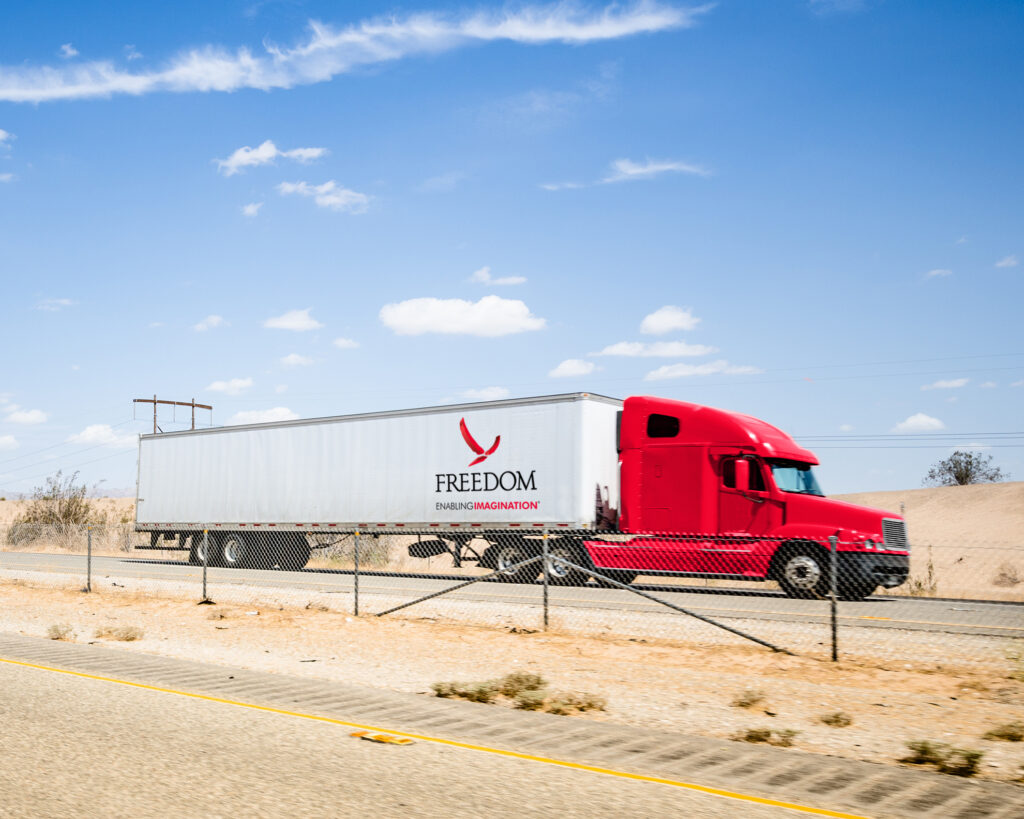Freedom branded delivery truck on the road.